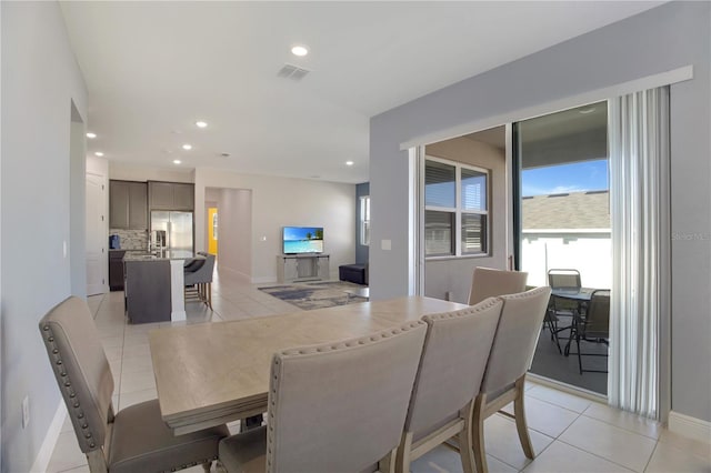 dining space featuring light tile patterned floors