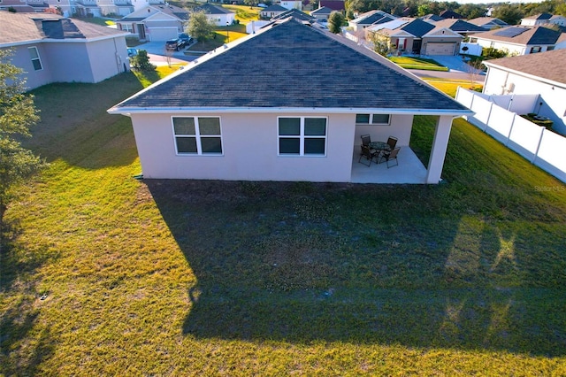 exterior space with a patio area and a lawn