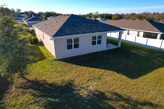 view of side of property with a lawn