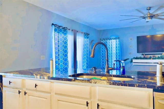 kitchen with sink, white cabinetry, and ceiling fan