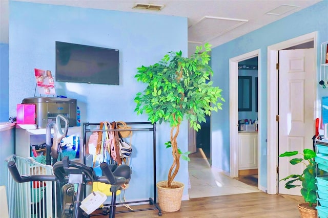 interior space with visible vents and wood finished floors