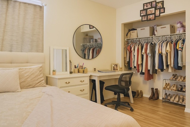 bedroom with baseboards and wood finished floors