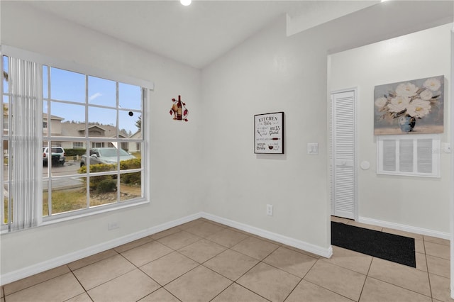 unfurnished room with plenty of natural light and light tile patterned floors