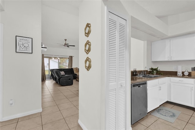 kitchen with dishwasher, white cabinetry, sink, ceiling fan, and light tile patterned floors