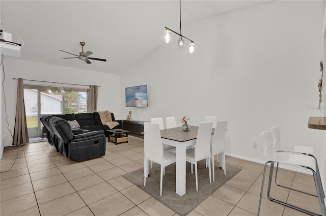 dining space with ceiling fan, light tile patterned floors, and lofted ceiling