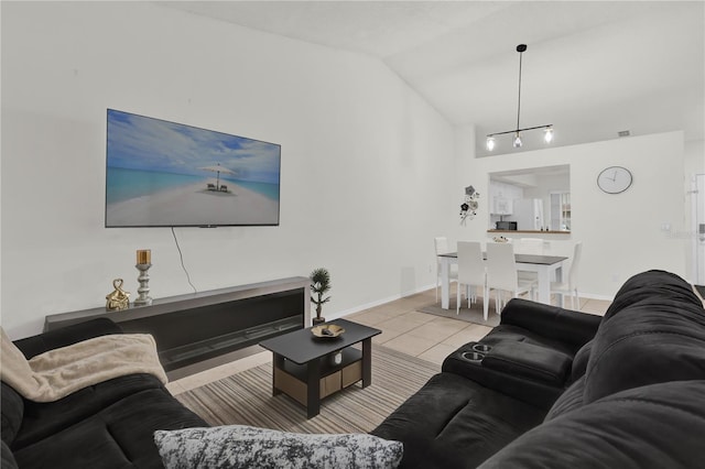 living room with light tile patterned floors and lofted ceiling