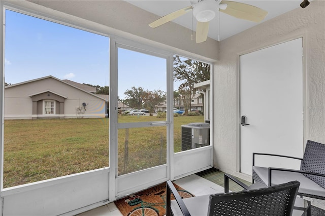 sunroom featuring ceiling fan