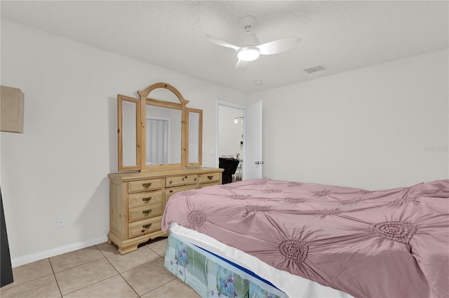 tiled bedroom featuring ceiling fan and a textured ceiling