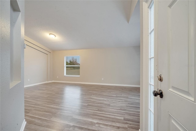 interior space featuring a textured ceiling and light hardwood / wood-style floors