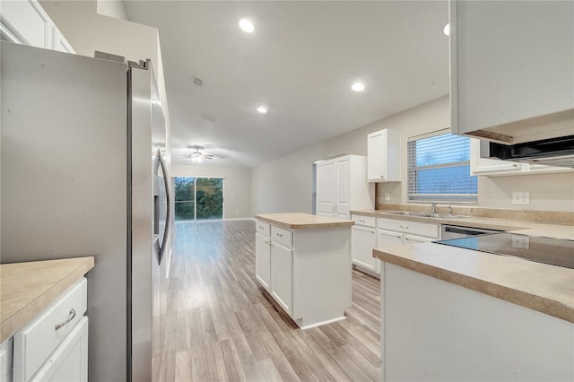 kitchen with a center island, stainless steel fridge, light hardwood / wood-style floors, white cabinets, and ceiling fan