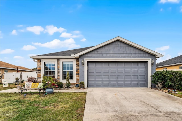 view of front of property featuring a front yard and a garage