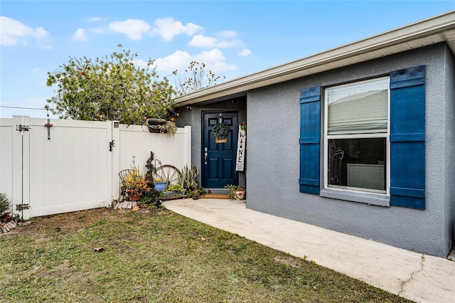 entrance to property featuring a yard