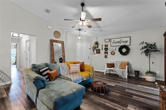 living room featuring ceiling fan, vaulted ceiling, and dark wood-type flooring