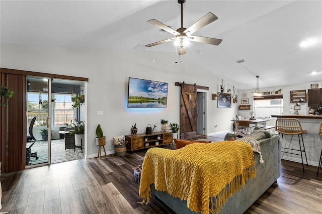 living room with lofted ceiling, a barn door, ceiling fan, and dark wood-type flooring