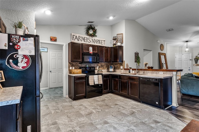 kitchen featuring lofted ceiling, a textured ceiling, black appliances, dark brown cabinetry, and sink