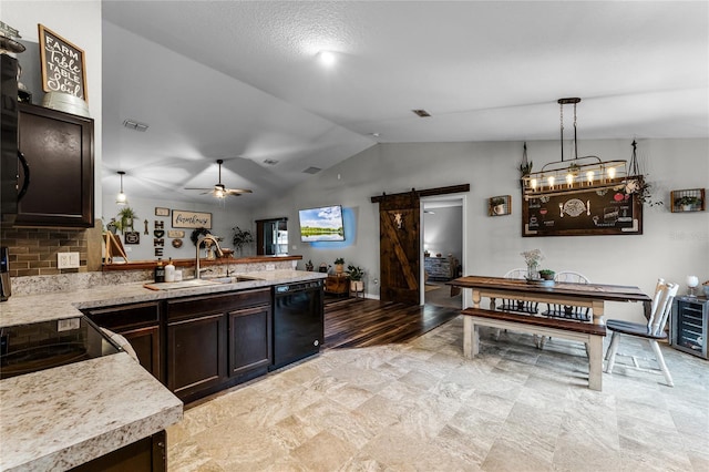 kitchen featuring pendant lighting, dishwasher, sink, ceiling fan, and a barn door