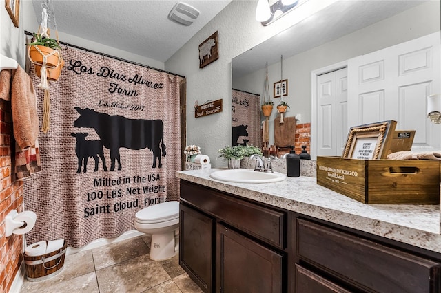 bathroom featuring a textured ceiling, toilet, walk in shower, and vanity