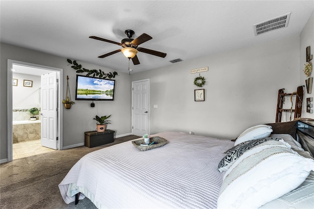 carpeted bedroom featuring ceiling fan and ensuite bath