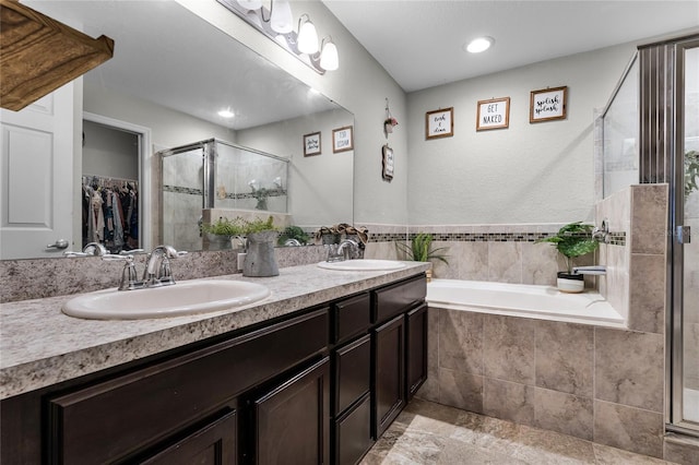 bathroom featuring vanity and shower with separate bathtub