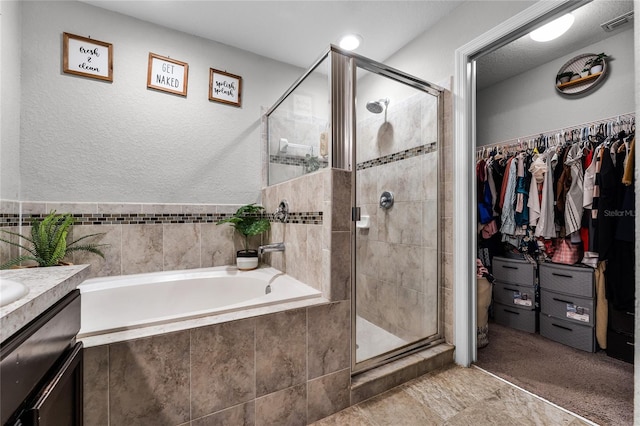 bathroom with independent shower and bath and vanity