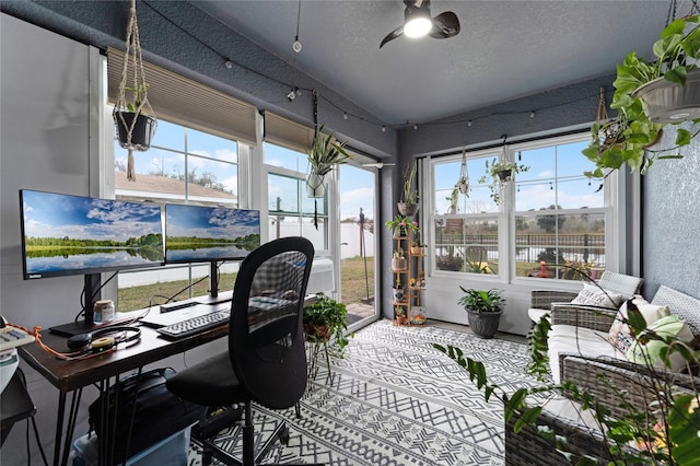 office with ceiling fan and a textured ceiling