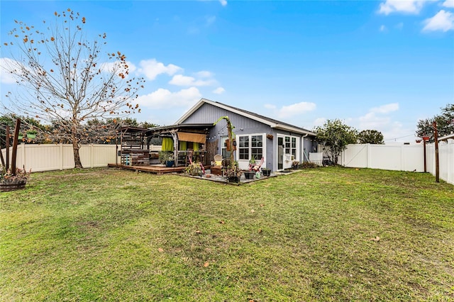 rear view of property featuring a patio area and a lawn