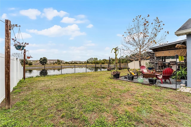 view of yard featuring a water view and a fire pit