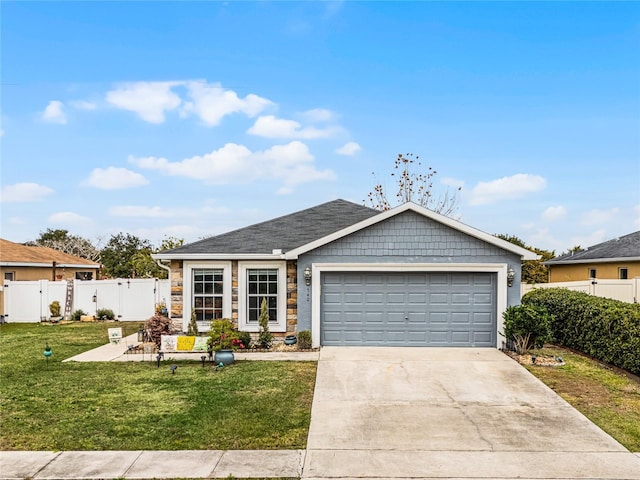 view of front of property with a garage and a front lawn