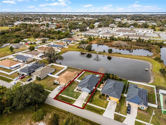 birds eye view of property with a water view