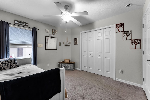 carpeted bedroom with ceiling fan and a closet