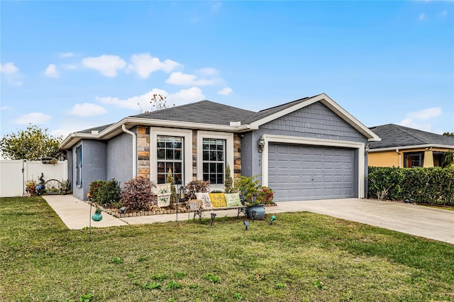 540 E 19th St, Saint Cloud, FL 34769 - ranch-style house featuring driveway, a front yard, stone siding, fence, and a garage
