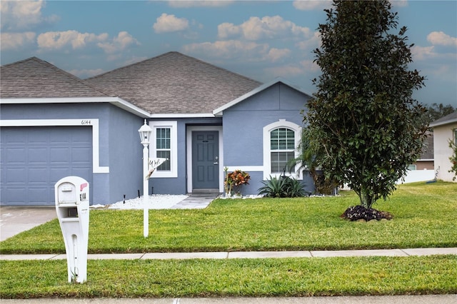 ranch-style home featuring a front yard and a garage