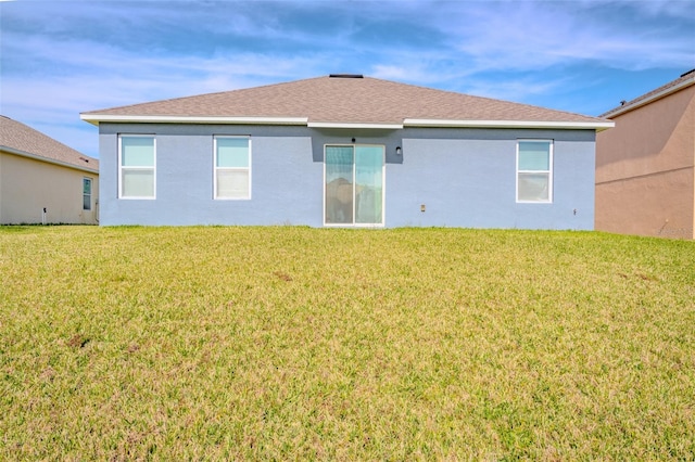 back of house featuring a lawn