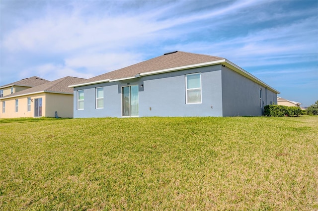 rear view of house with a lawn