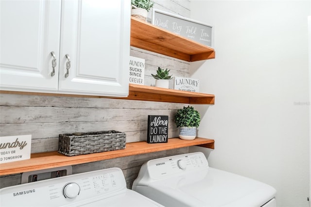 laundry room featuring cabinets and washer and dryer