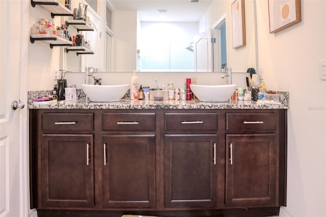 bathroom featuring vanity and a shower