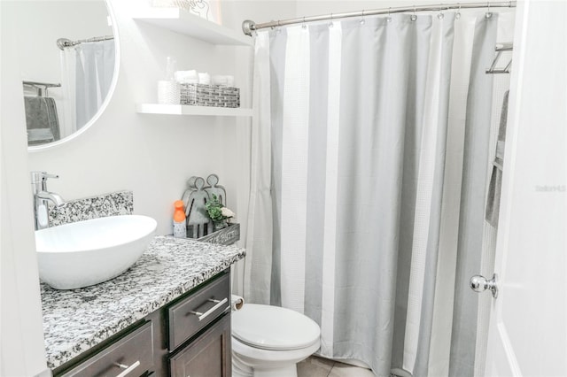 bathroom featuring vanity, toilet, and tile patterned flooring