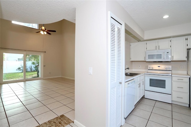 kitchen with white cabinetry, sink, white appliances, a textured ceiling, and light tile patterned flooring