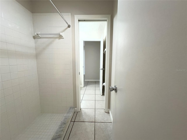 bathroom featuring tiled shower and tile patterned floors