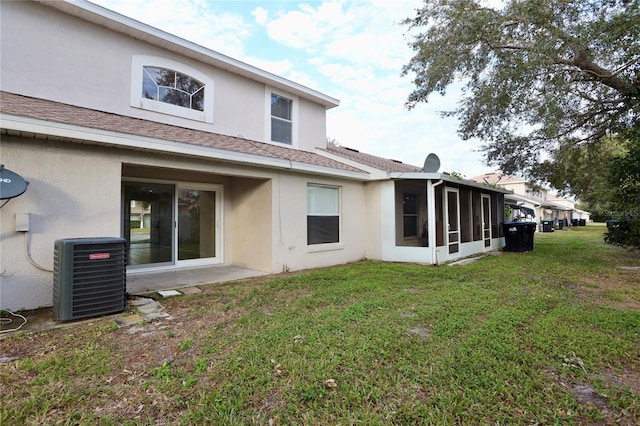 back of house featuring a yard, cooling unit, and a sunroom