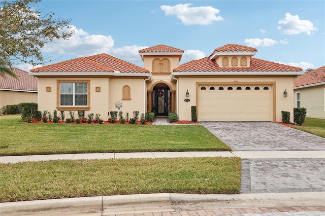 mediterranean / spanish-style home with a front lawn and a garage