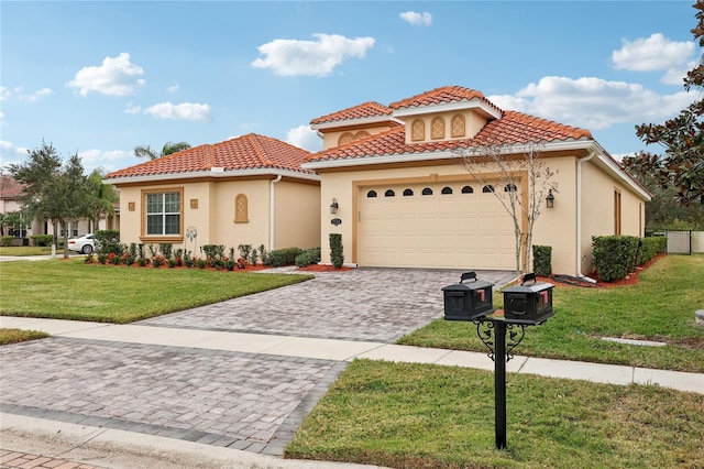 mediterranean / spanish home featuring a front lawn and a garage