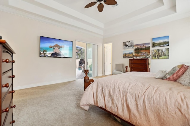 bedroom with light carpet, ceiling fan, access to outside, a tray ceiling, and ornamental molding