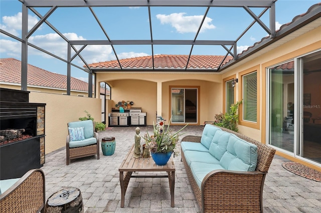 view of patio featuring a fireplace and exterior kitchen