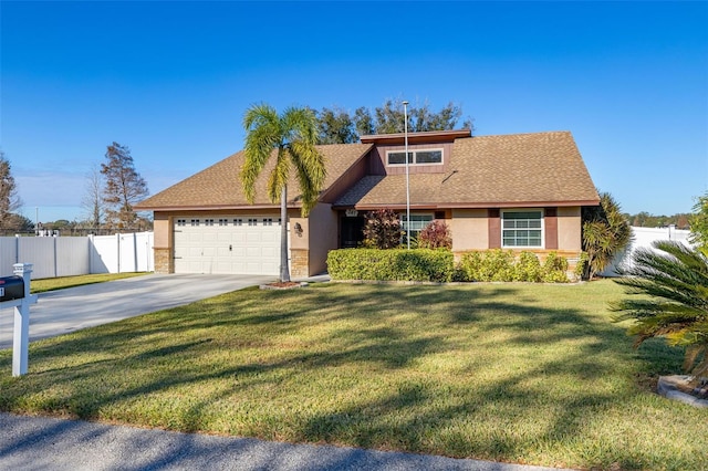 view of front of home featuring a front yard and a garage