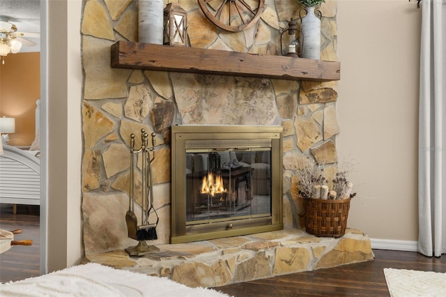 interior details featuring wood-type flooring, a fireplace, and ceiling fan