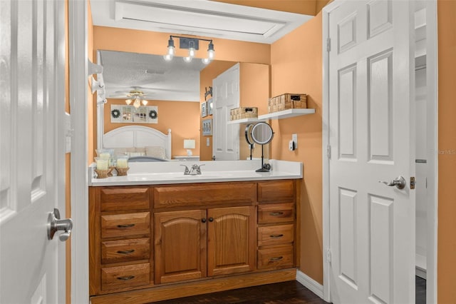 bathroom with ceiling fan, a textured ceiling, vanity, and hardwood / wood-style flooring