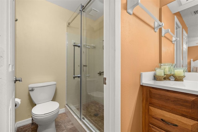 bathroom with an enclosed shower, vanity, and toilet