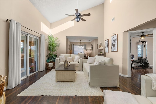 living room with ceiling fan, a wealth of natural light, and dark hardwood / wood-style floors