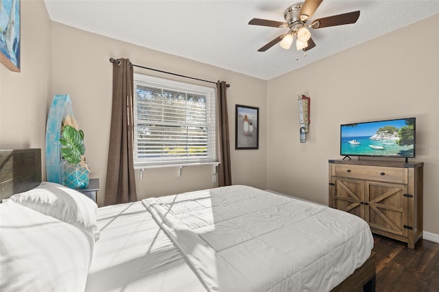 bedroom with ceiling fan and dark hardwood / wood-style floors